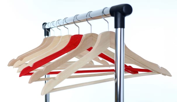 Red and wooden hanger hanging on metal pipe business leader selling clothes and style