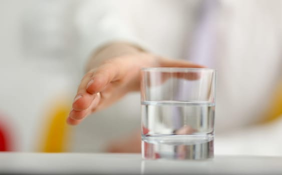 Male arm stretching out to glass in office closeup