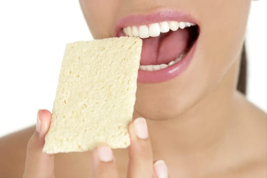 Biscuit in woman teeth and mouth having a healthy snack