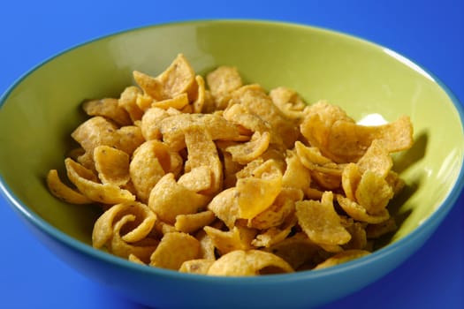 Fried corn golden snack in plate over blue background