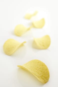 Potato salted chips slices over white background