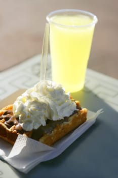 Delicious breakfast meal with lemonade and cream waffle pastry