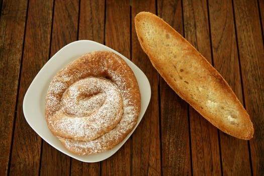 Breakfast with bread toast and ensaimada pastry from Spain