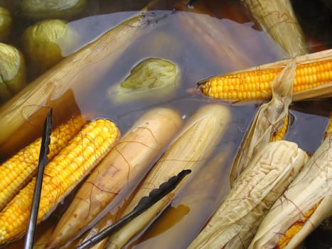corn cobs and chayote merlitons boiling on water in mexico