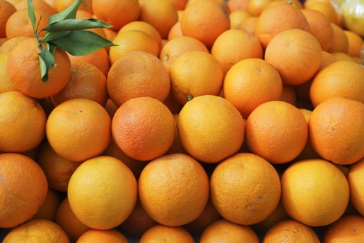 Valencia oranges stacked on market in mediterranean spain