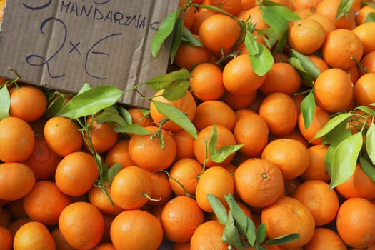 Valencia oranges stacked on market in mediterranean spain