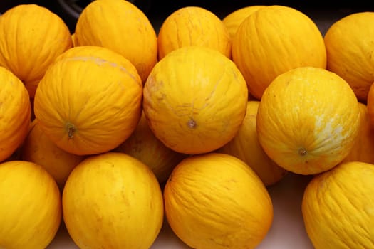 Canary Yellow Melon Indorus melo market stacked rows arrangement