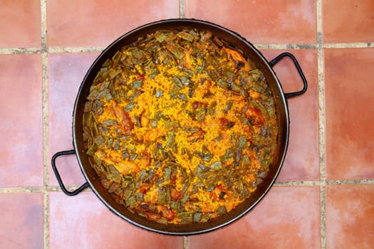 Paella rice recipe Mediterranean Spain round pan on clay floor