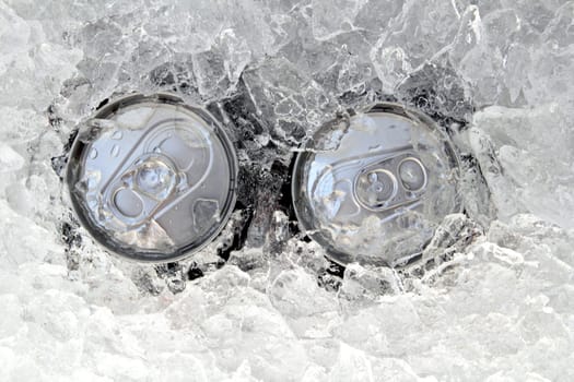 two drink can iced submerged in frost ice closeup