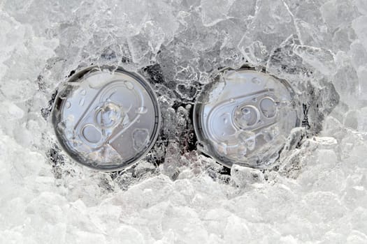 two drink can iced submerged in frost ice closeup