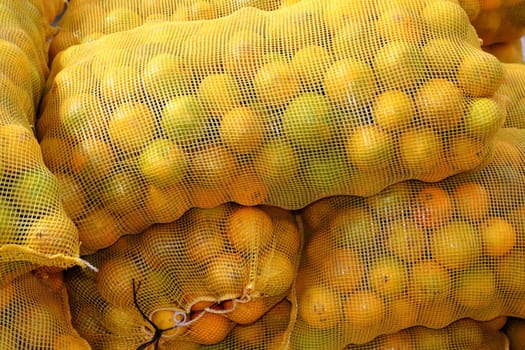 many orange sack citrus stacked fruits