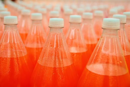 orange juice beverage plastic bottle in factory line