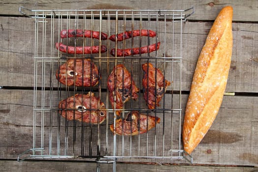 barbecue sausages lamb meat grill bread on wooden table