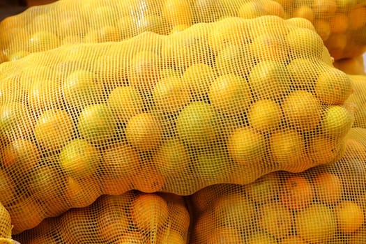 many orange sack citrus stacked fruits