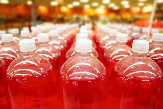assembly line bottle red liquid rows lines perspective
