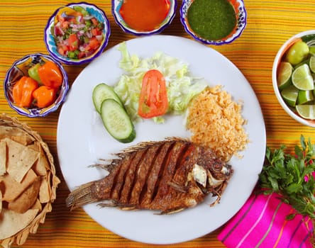 fried mojarra tilapia fish Mexico style with chili sauce and nachos