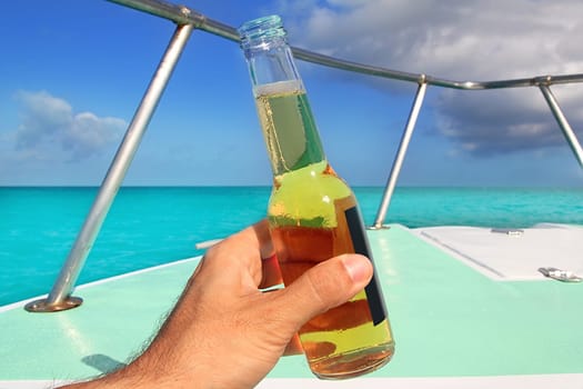 beer on hand Caribbean in boat bow turquoise sea enjoying vacation
