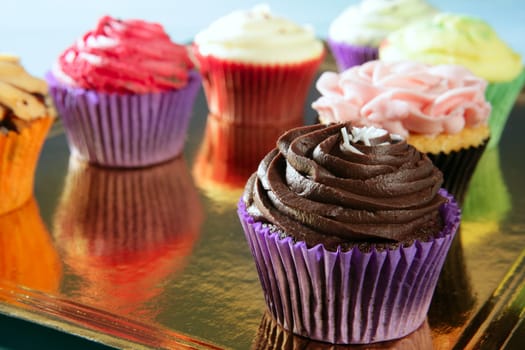 colorful cupcakes on a golden mirror tray