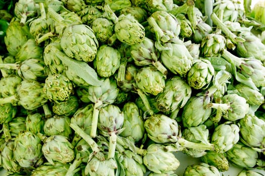 artichokes vegetables in a market stacked mound healthy food