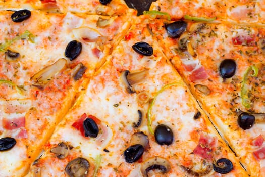 closeup of pizza with olives tomato cheese pepper and mushrooms