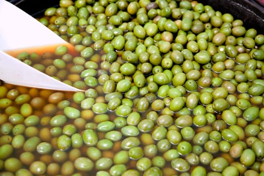 brine green olive fruits in market round pot