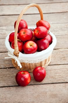 basket of red apples on wood floor aerial view