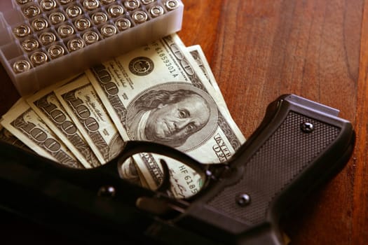 Dollar notes and gun, black pistol, mafia inspiration