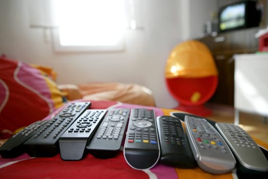 many remote control for only one house, excess technology metaphor
