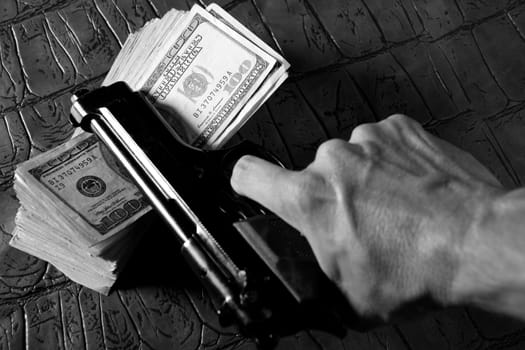 Dollar notes and gun, black pistol, mafia inspiration
