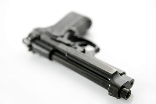 black hand gun pistol over white background, selective focus, studio shot