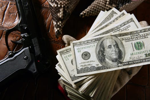 Dollar notes and gun, black pistol, mafia inspiration