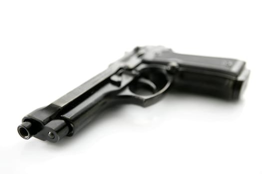 black hand gun pistol over white background, selective focus, studio shot