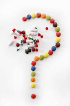 Candy sweets question mark isolated over white background and pills
