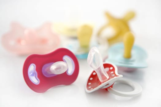 baby pacifier set isolated over white background, studio shot