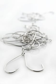 fishing hooks over white background, fisherman equipment