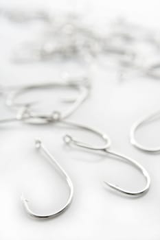 fishing hooks over white background, fisherman equipment