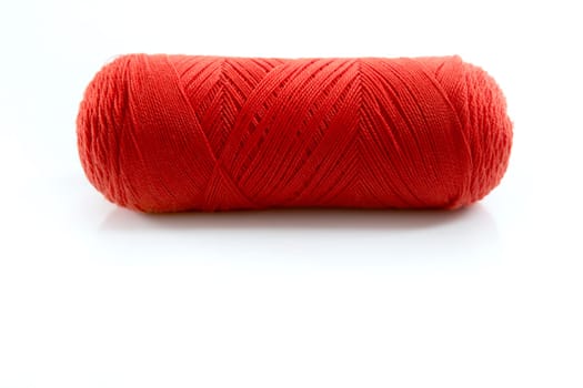 Red thread spool isolated over white studio background