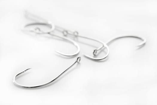 fishing hooks over white background, fisherman equipment
