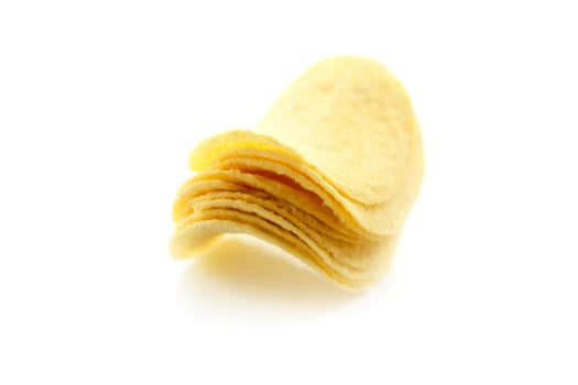 potato chips satacked isolated over white studio background
