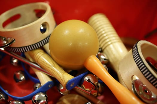 mixed percussion toy instruments over red background