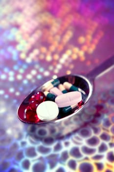 Silver spoon full of medicine pills over holographic background