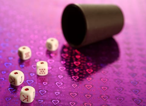 Poker dices over colored background, selective focus