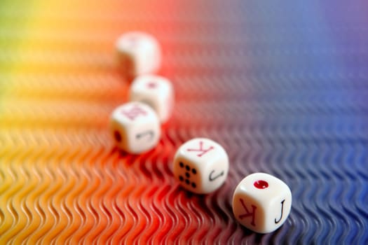 Poker dices over colored background, selective focus