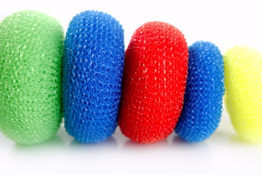 Domestic colorful sponge washer for dishes in a row isolated over white