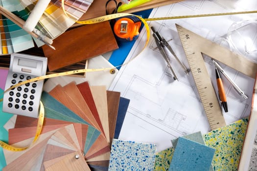 Architect or interior designer workplace desk and design tools with lots of construction material samples