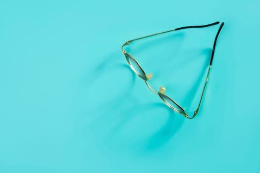doctor glasses with soft shadow over green desk background