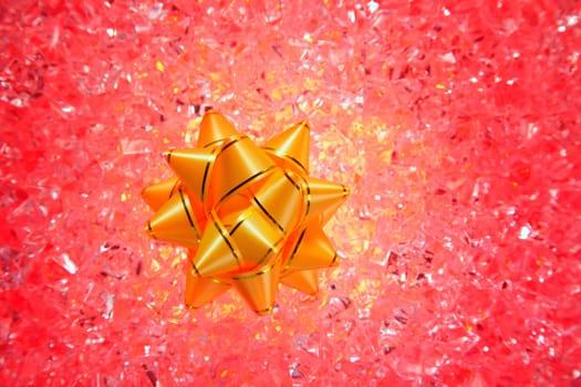 christmas gift golden ribbon on red ice background