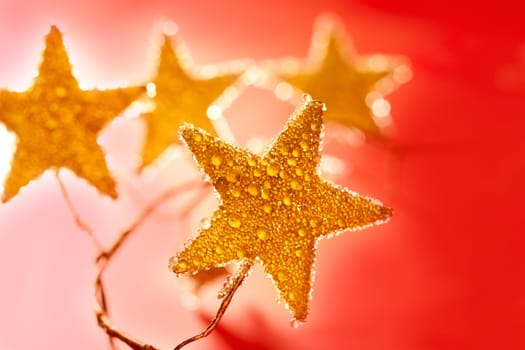 christmas golden drops star in red background