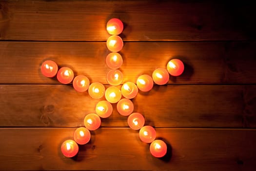 christmas candles pentagram star on golden warm wood