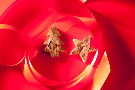 Christmas tree and star of tree bark on red background and ribbon